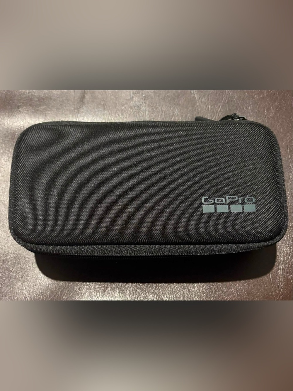 GoPro Camera with Black Zippered Travel and Gear Pouch